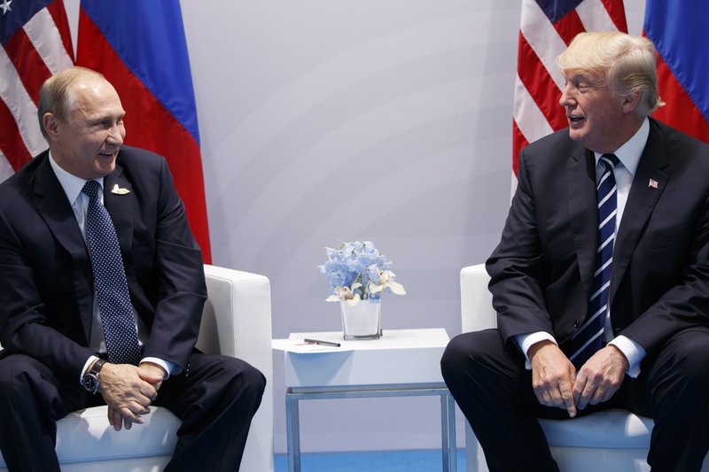 Image result for US President Donald Trump shakes hands with Russian President Vladimir Putin during their bilateral meeting at the G20 summit in Hamburg in July 2017.
