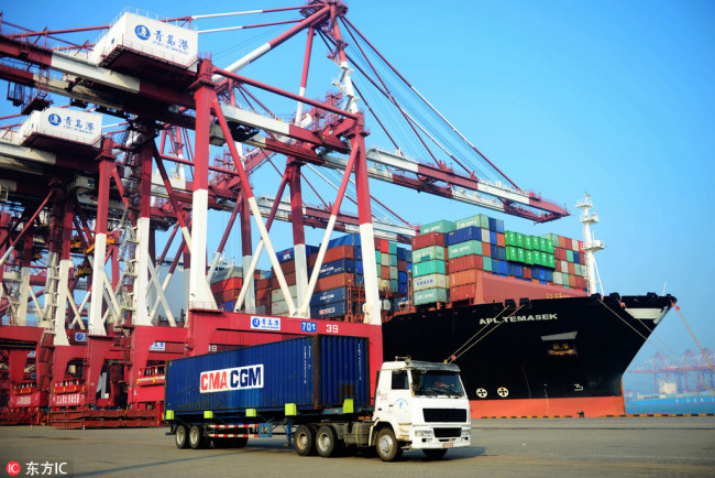 A truck transports a container to be shipped abroad at the Port of Qingdao, east China´s Shandong province, on July 13, 2017. [File photo: IC]