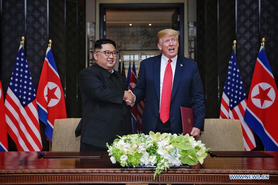 Top leader of the Democratic People's Republic of Korea (DPRK) Kim Jong Un (L) shakes hands with U.S. President Donald Trump during the signing ceremony of a joint statement in Singapore on June 12, 2018.[Photo: Xinhua]