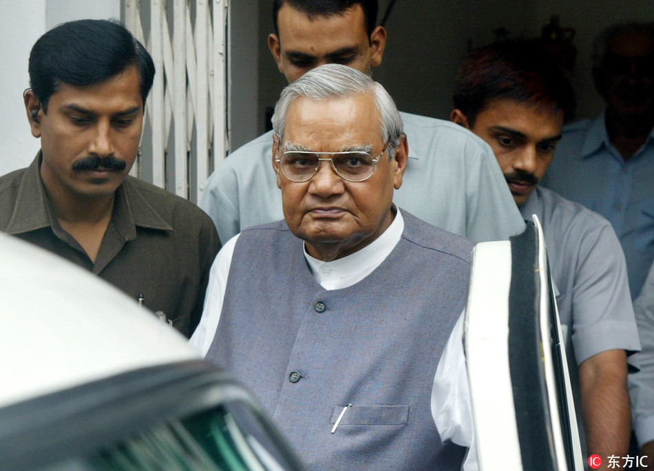 In this Aug. 23, 2004 file photo, senior Bharatiya Janta Party (BJP) leader Atal Bihari Vajpayee, center, leaves after a meeting at the party headquarters in New Delhi, India.[File Photo: IC]