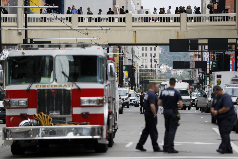 Civilians are escorted from the Fifth Third Center as emergency personnel and police work the scene of shooting near Fountain Square, Thursday, Sept. 6, 2018, in downtown Cincinnati. [Photo: AP/John Minchillo]