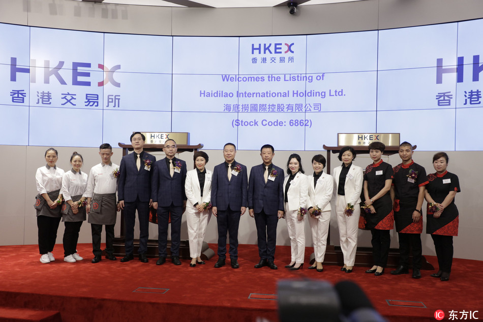 Zhang Yong, center right, the founder and CEO of Haidilao International Holding Ltd., poses during the ceremony for the listing of the hotpot chain on the Hong Kong Stock Exchange (HKEX) in Hong Kong on Wednesday, September 26, 2018. [Photo: IC]