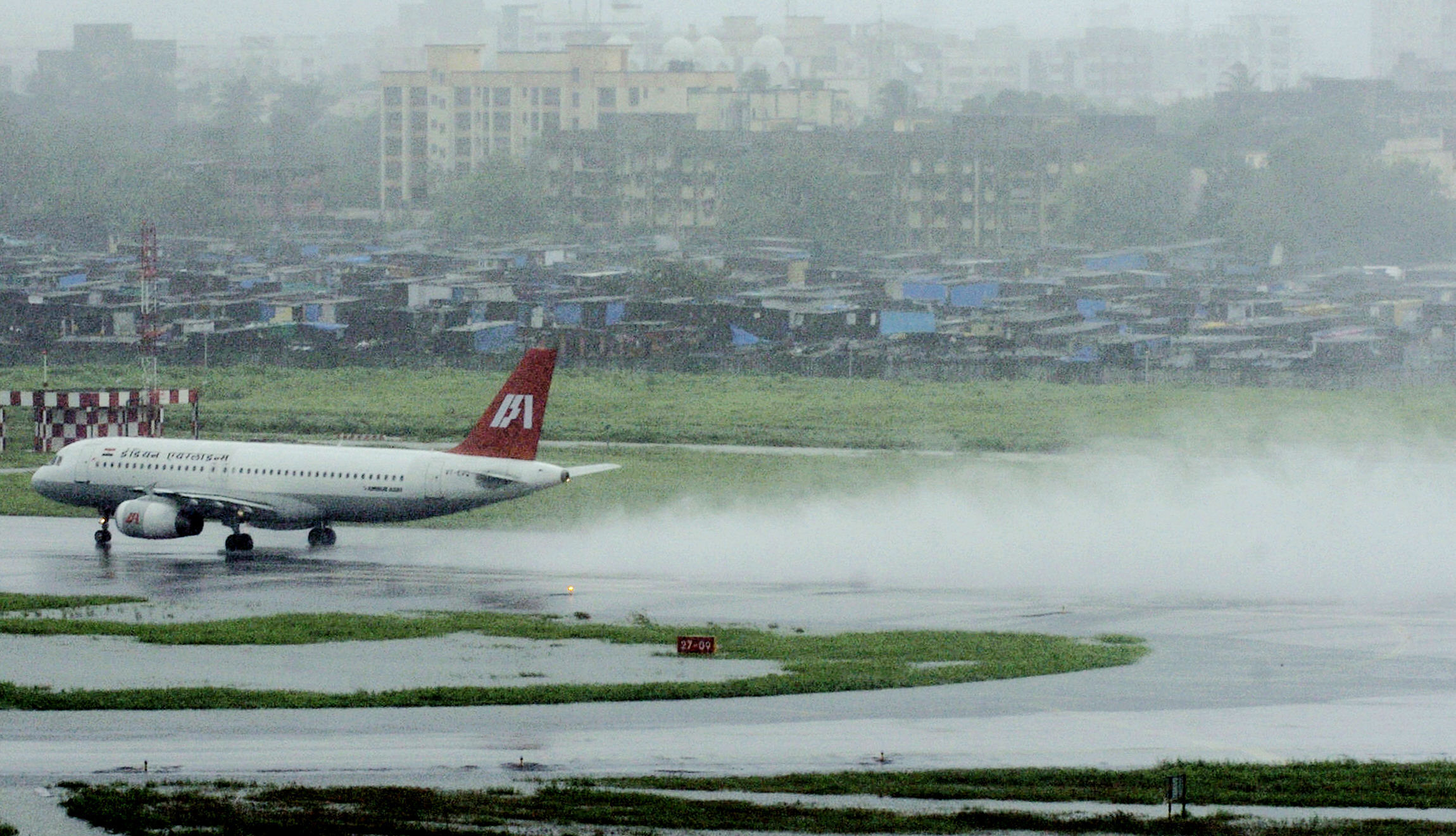 An Indian Airlines aircraft takes off amidst heavy rain from the Chhatrapati Shivaji International airport, in Mumbai 01 August 2005. [File Photo: AFP/INDRANIL MUKHERJEE]