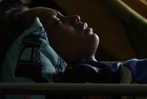 Anisa Cornelia grimaces in pain as she lies inside a medical tent after being injured in a massive earthquake and tsunami in Palu, Central Sulawesi, Indonesia Thursday, Oct. 4, 2018. [Photo: AP]