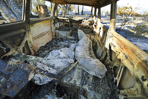 Surfboards are seen inside a destroyed Volkswagen van at a home destroyed by the Woolsey Fire on Dume Drive in the Point Dume area of Malibu in Southern California, Tuesday, Nov. 13, 2018. [Photo: AP]