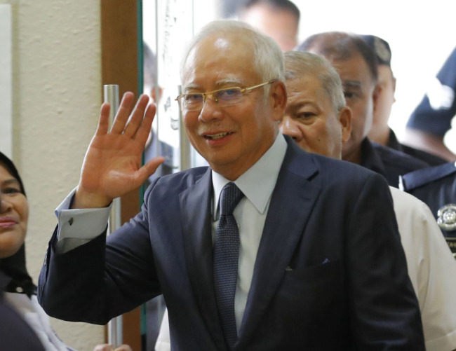 Former Malaysian Prime Minister Najib Razak walks into courtroom at Kuala Lumpur High Court in Kuala Lumpur, Malaysia, Thursday, Oct. 4, 2018. Najib arrived in court for the management of his corruption trial involving the 1mdb state investment fund. [Photo: AP]