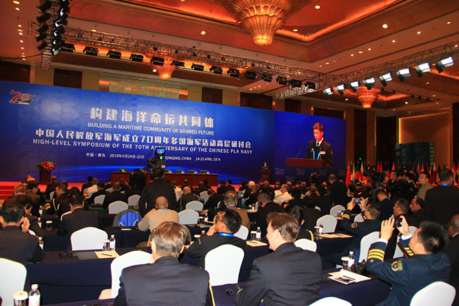 The photo shows the representatives of Chinese and other countries' navies attend the seminar on the theme of Building a Maritime Community of Shared Future in Qingdao on Apr 24, 2019. [Photo provided to China Plus]